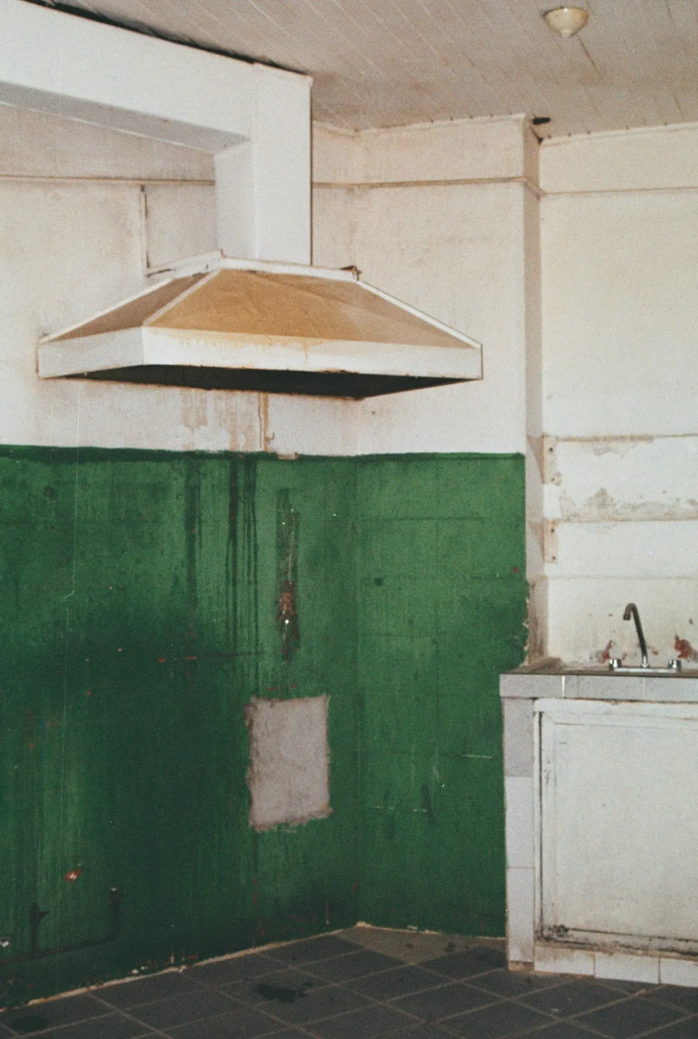 Neglected kitchen extraction canopy with staining and build-up, overdue for service