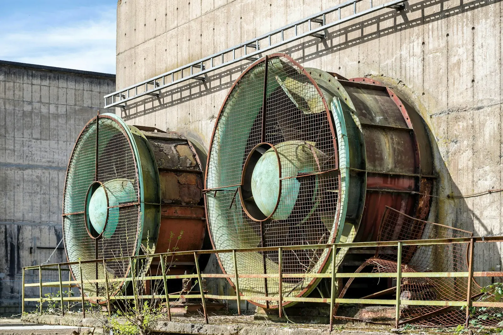 Corroded rooftop extraction fans left unserviced and structurally deteriorating