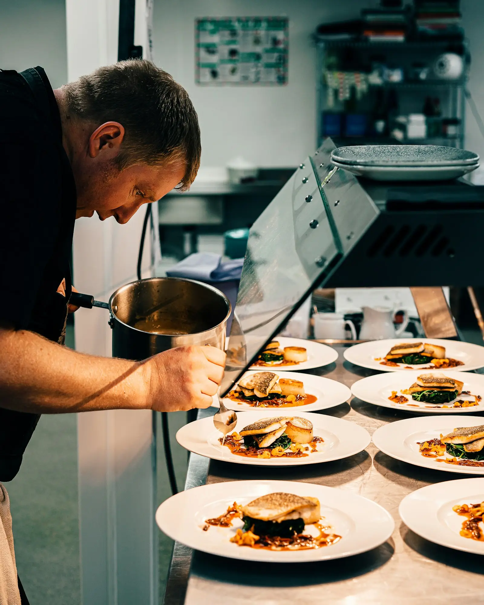 Chef working the line in a stainless steel commercial kitchen