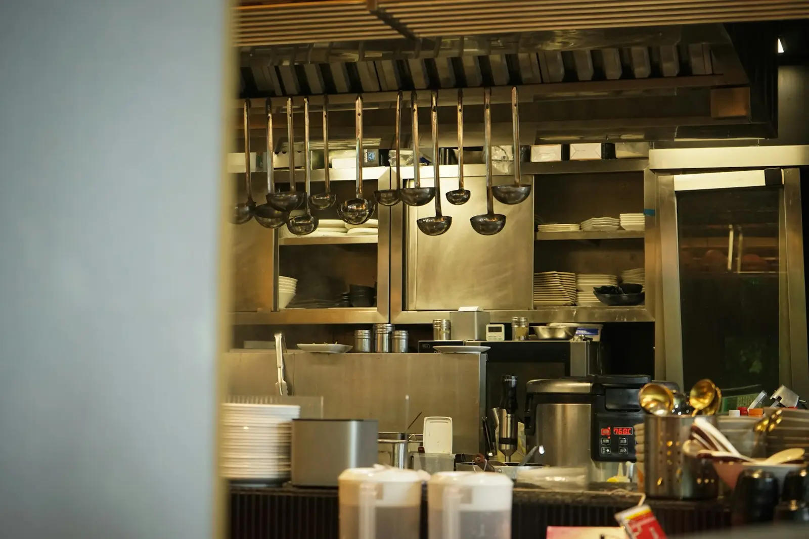 Utensils hanging on a rail in a professional kitchen